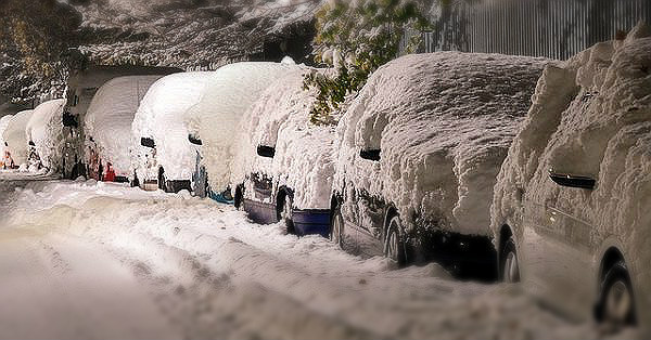 cold weather cars covered in snow on street in winter